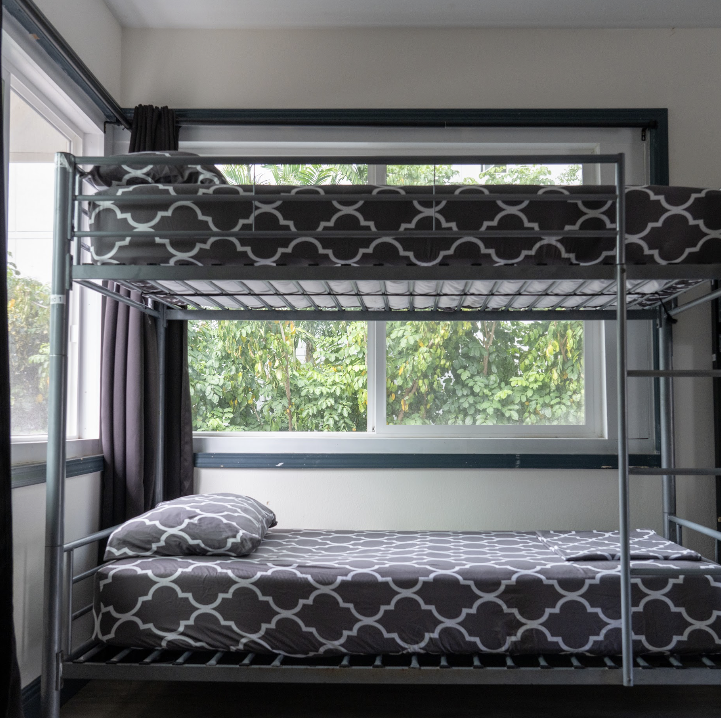 Women’s 2-bed dorm with one bunk bed beside the windows